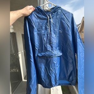 Vintage 80’s Lacoste alligator blue hooded windbreaker with zip front pocket.